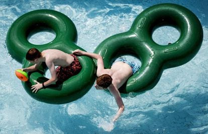 Dos niños se divierten en un flotador en el parque de atracciones Duinrell (Holanda), el 21 de junio.