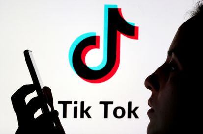 Una persona sujeta un móvil con el logo de TikTok.