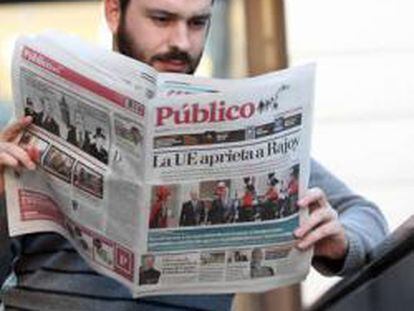 Un lector con un ejemplar del periódico Público