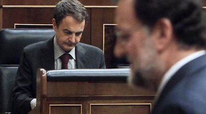 Mariano Rajoy cruza ante Rodríguez Zapatero, sentado en el banco azul del Gobierno, durante el pleno de ayer.