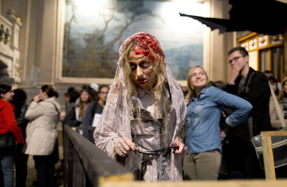 Una mujer disfrazada de zombie entretiene al público de 'La Peste' en Le Manoir, París.