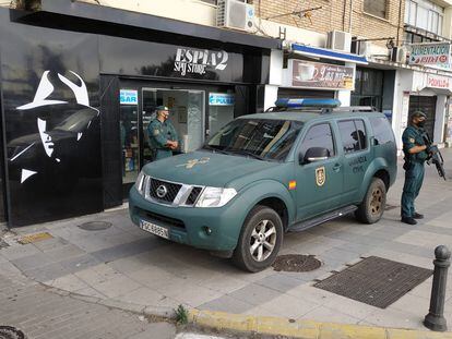 Agentes de la Guardia Civil custodian la puerta de un establecimiento durante un registro en Algeciras (Cádiz), este miércoles.