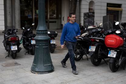 Un hombre camina entre motos que ocupan parte del espacio público en la Via Laietana de Barcelona, acabada de reformar, este viernes.