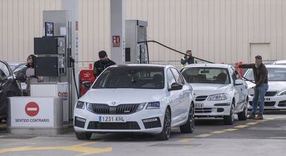 Varios clientes repostan carburante en su vehículo en una gasolinera de Sevilla.