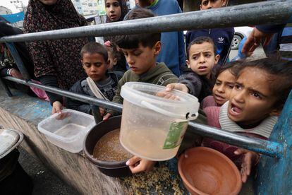 A group of children wait their turn to receive food in Rafah on February 13. 