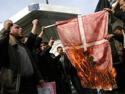 Militantes del grupo palestino Comité de Resistencia Popular queman una bandera de Dinamarca en Gaza.