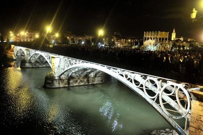 La Esperanza de Triana cruza el puente de Triana en la 'madrugá' de Sevilla.