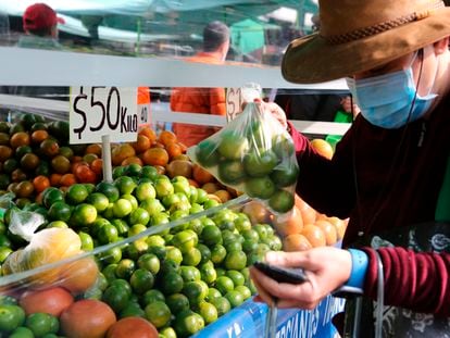 Un cliente compra limones en un tianguis de Ciudad de México, en 2022.