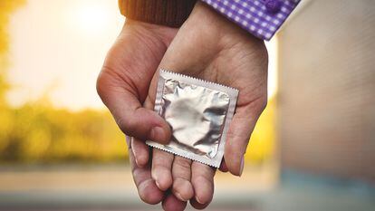 Men, women, couples Holding a condom for self-protection. Concept to prevent contraception.