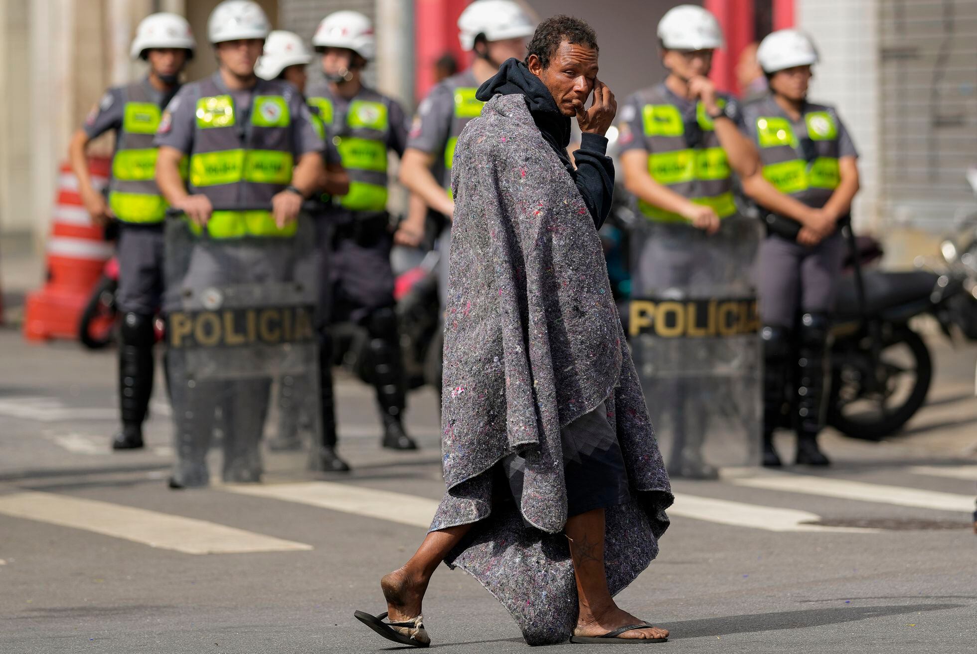 Un hombre que vivía Cracolandia, situado en la plaza Princesa Isabel, cruza la calle frente a las fuerzas policiales, el 11 de mayo de 2022.