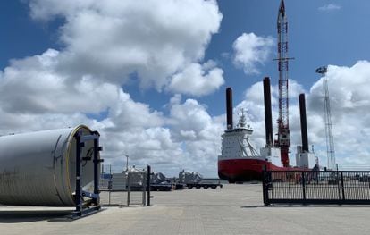 Un buque autoelevable, diseñado para poder transportar palas y turbinas eólicas, atracado en el puerto de Esbjerg (Dinamarca). A la izquierda, una de estas estructuras.