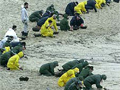 Grupos de militares limpian la playa de Ancoradoiro, en Muros (A Coruña).