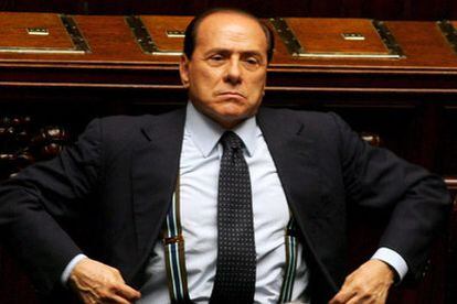 El primer ministro Silvio Berlusconi se ajusta la chaqueta durante la sesión de ayer en el Parlamento italiano.