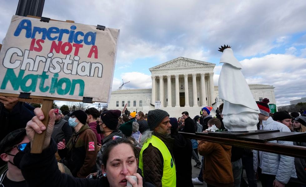 An abortion rights activist, left, protests as people carry a statue of Our Lady of Fatima outside of the U.S. Supreme Court during the March for Life, Friday, Jan. 20, 2023, in Washington. (AP Photo/Alex Brandon)