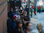People queue outside the Waitrose and Partners supermarket, amid the coronavirus disease (COVID-19) outbreak, in London, Britain December 22, 2020. REUTERS/Hannah McKay