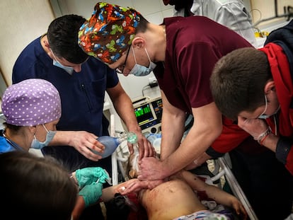 FILE - Medics perform CPR on a girl at the city hospital of Mariupol, who was injured during shelling, in a residential area, in eastern Ukraine, Sunday, Feb. 27, 2022. The girl did not survive. (AP Photo/Evgeniy Maloletka, File)