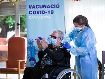 Josefa Pérez de 89 años aplaude acompañada de una sanitaria, tras ser la primera mujer en vacunarse en Cataluña. DICIEMBRE 2020 Pau Venteo / Europa Press