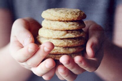 Un niño sujeta seis galletas.