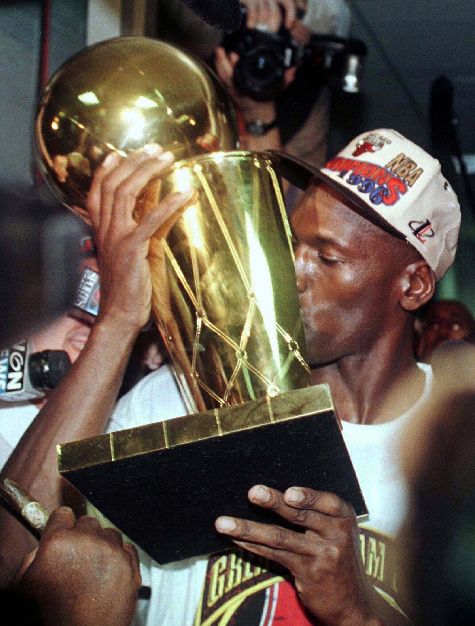 Michael Jordan besa el trofeo de la NBA.