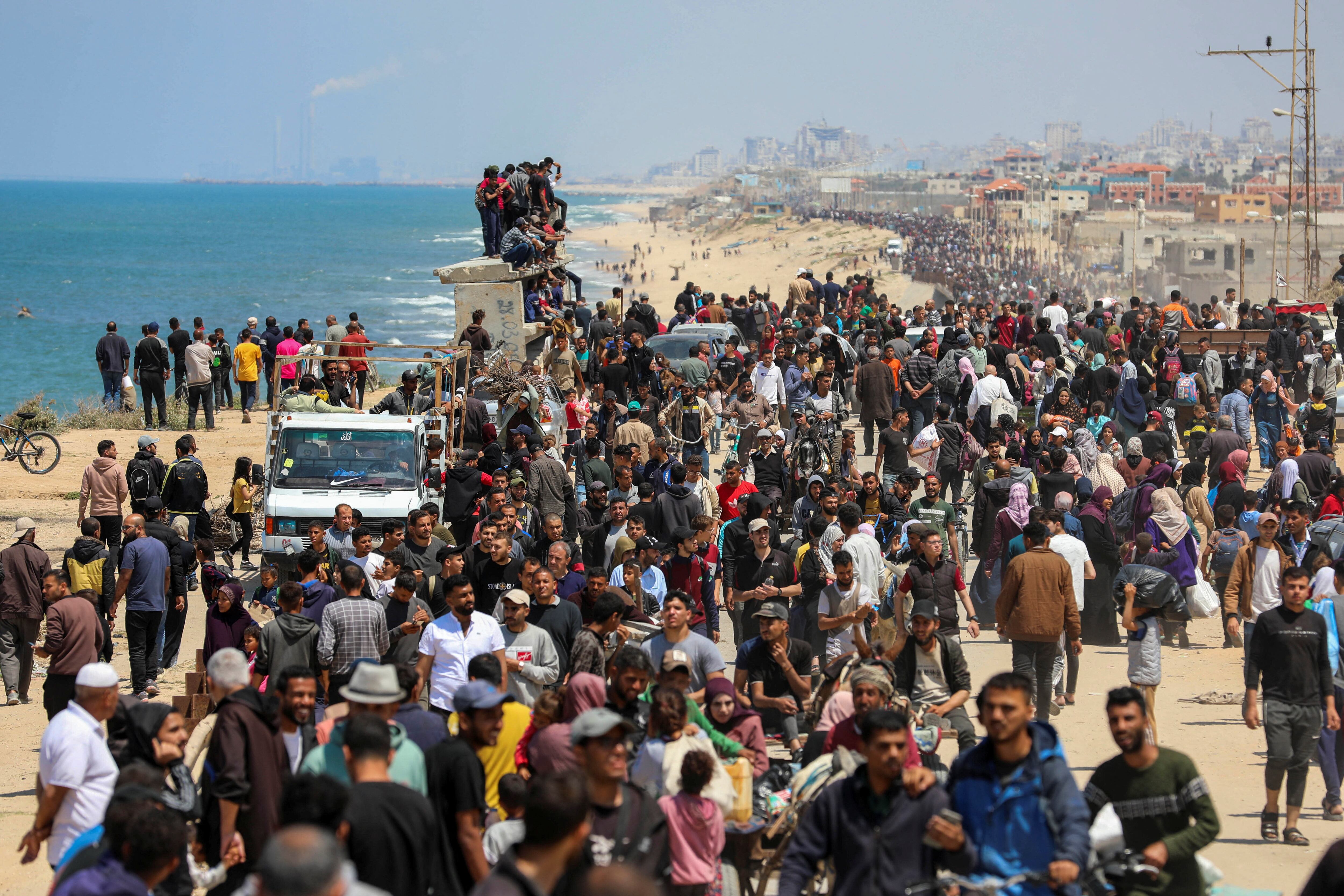 Palestinians, who were displaced by Israel's military offensive on south Gaza, make their way as they attempt to return to their homes in north Gaza, amid the ongoing conflict between Israel and Hamas, as seen from central Gaza Strip April 14, 2024. REUTERS/Ramadan Abed