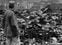 ** FOR USE AS DESIRED WITH UPCOMING HIROSHIMA ANNIVERSARY ** ** FILE ** An allied correspondent stands in the rubble of the shell of a building that once was a movie theater in Hiroshima, Japan, on Sept. 8, 1945 after the first nuclear weapon ever used in warfare was dropped by the U.S. on Aug. 6, 1945 to hasten Japan's surrender. Estimates vary, but about 140,000 people are believed to have died in the nuclear blast.  (AP Photo/Stanley Troutman)