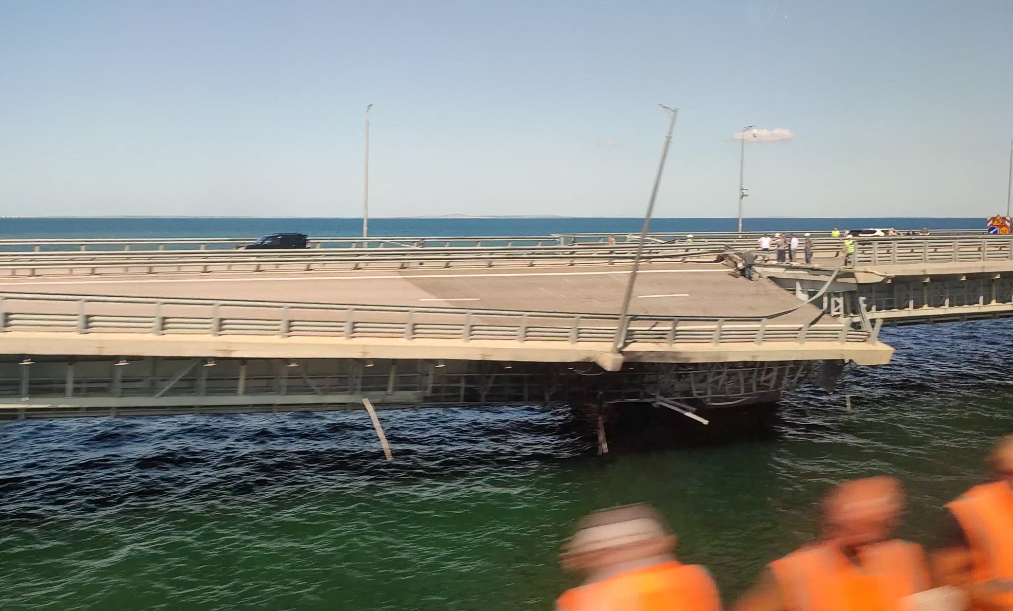 A view through a train window shows the section of a road split and sloping to one side following an alleged attack on the Crimea Bridge, that connects the Russian mainland with the Crimean peninsula across the Kerch Strait, in this still image from video taken July 17, 2023. REUTERS/Stringer / STRINGER / via REUTERS