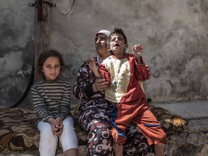 Shihan Suleiman, de 40 años, ha huido a pie del enclave kurdo de Afrin al poblado de Tel Rifat, cargando con su hija Fátime de 15 años que padece una enfermedad mental