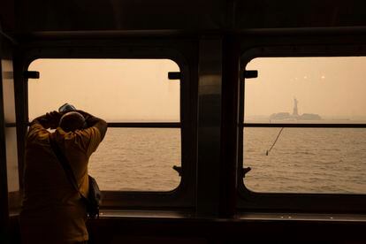 Un hombre mira la Estatua de la Libertad desde el ferry de Staten Island, el 7 de junio.