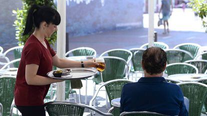 Una camarera sirve una consumici&oacute;n en una terraza de Valladolid. 