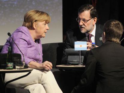 Mariano Rajoy conversa con Angela Merkel, durante el encuentro que mantuvieron ayer en Santiago de Chile.