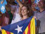 People cheer as they attend the official launch of Catalonia's main separatist parties' campaign for an independence referendum at the Tarraco arena in Tarragona on September 14, 2017.  Catalan separatists launched their campaign today for a banned independence referendum in front of thousands of cheering supporters, despite growing desquiet in Spain as pressure mounts to stop the vote at all cost. / AFP PHOTO / Josep LAGO