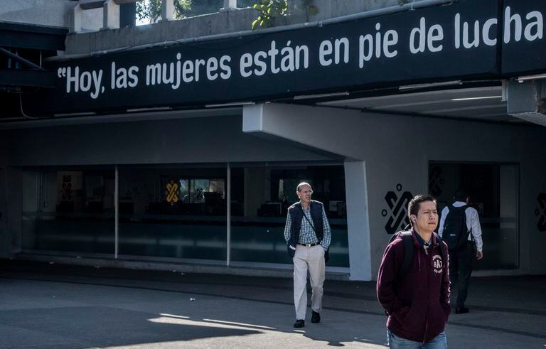 Hombres caminan en la estacin de metro Insurgentes una de las ms transitadas y concurridas de la ciudad frente de un cartel con consignas el da 09 de marzo de 2020 en Ciudad de Mxico. Las mujeres mexicanas estn llamadas a hacer historia tambin este lunes. Despus de haber desbordado las calles de las principales ciudades del pas con la multitudinaria manifestacin del 8M, el pas afronta un paro indito de la poblacin femenina este lunes. Los colectivos feministas hicieron un llamado a un paro para visibilizar a las mujeres mediante una ausencia que se prev tan masiva como la protesta del domingo. Es la primera vez que se pondr a prueba un acto de resistencia de esta naturaleza, que se ha convertido en accin poltica y econmica que rezuma el hartazgo por la inseguridad y la brecha entre hombres y mujeres.