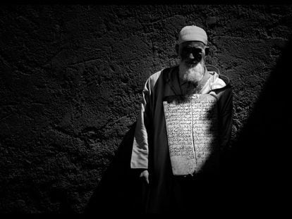 Este anciano 'taleb' posa con una vieja tabla ante el muro de la escuela coránica. "Medio en penumbra", dice Gabú, "las luces y las sombras del sol africano continuaban iluminando mi discurso artístico y emocional".