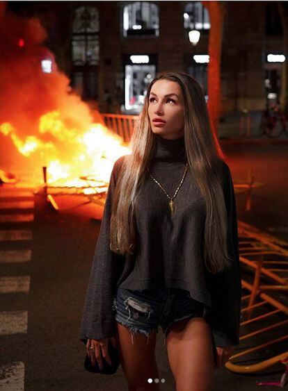 La influencer rusa Elena Rybalchenko, conocida como 'mama_fitness', posa frente a una de las hogueras que estos días avivan las protestas en Barcelona.