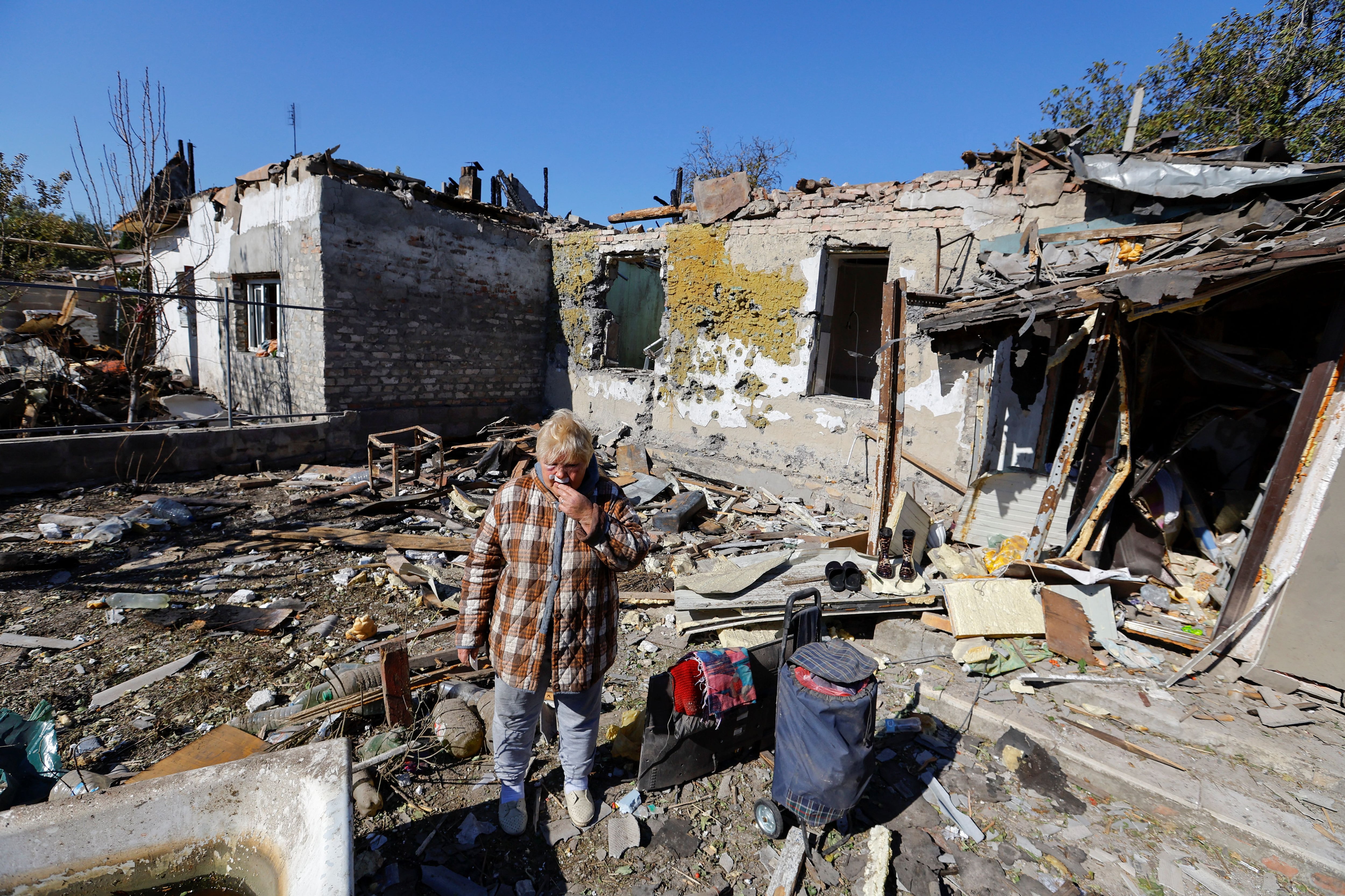 SENSITIVE MATERIAL. THIS IMAGE MAY OFFEND OR DISTURB Local resident Tatyana Gerpuleva, 75, injured by recent shelling stands outside her destroyed house in the course of Russia-Ukraine conflict in Donetsk, Russian-controlled Ukraine, September 24, 2023. REUTERS/Alexander Ermochenko