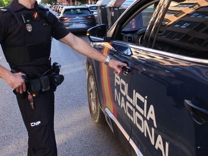 Un policía abre un coche policial en Valladolid.