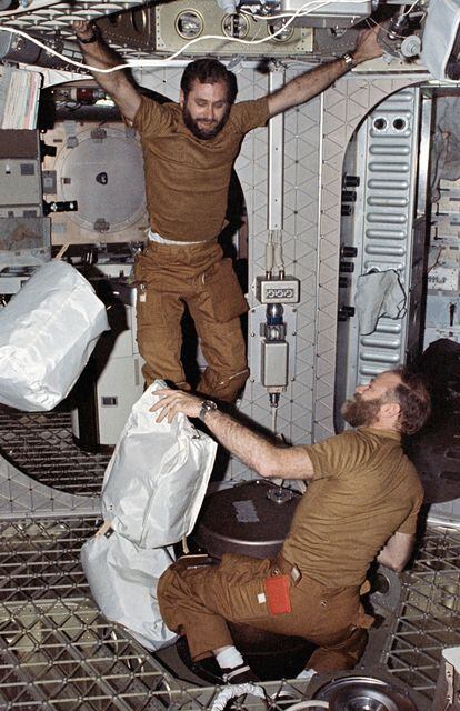 Pogue, left, and Carr place bags in the trash chute.