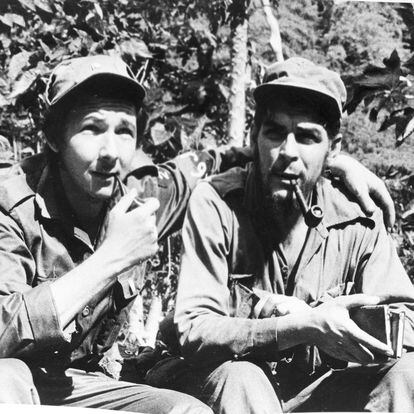 Raul Castro, left, younger brother of Cuban rebel leader Fidel Castro, smokes a pipe with his chief lieutenant, Ernesto Guevara of Argentina shown in their Sierra Cristal mountain stonghold in eastern Cuba, April 1958. (AP Photo/Andrew St. George)