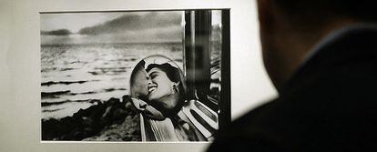 Un hombre observa en la exposición de la Fundación Canal la fotografía<i> California, 1955</i>, de Elliott Erwit.