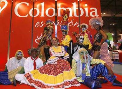 Varias personas ataviadas con trajes típicos de Colombia posan en el stand de Fitur.
