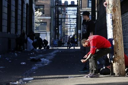 A man injects himself on the streets of Vancouver, Canada, in April 2020.
