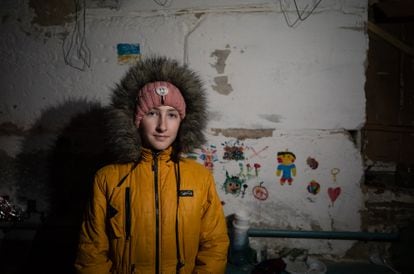 Yulia Semenova, in front of her drawings in the basement.