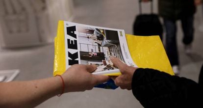 FILE PHOTO: An IKEA worker hands out catalogues at the entrance to an IKEA store in Madrid