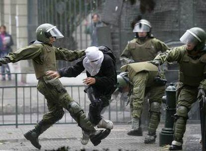 La policía antidisturbios se emplea la violencia con un joven encapuchado durante las protestas por el "Día del joven combatiente".