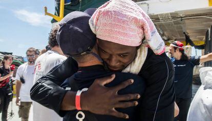 Abrazo entre uno de los migrantes y un voluntario del 'Aquarius', este domingo, en el puerto de Valencia.