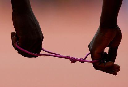 Detalle de las manos de la corredora keniata Priscah Jepkemei (dcha.) y de su guía antes del comienzo de la prueba de 200 metros femeninos.