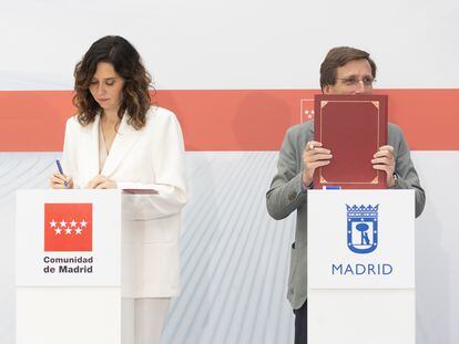 La presidenta de la Comunidad de Madrid, Isabel Díaz Ayuso y el alcalde de Madrid, José Luis Martínez-Almeida, durante la firma de un convenio de colaboración, en la Real Casa de Correos, este viernes.