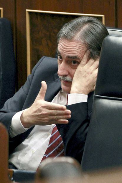 El ministro de Trabajo, Valeriano Gómez, habla por teléfono esta tarde en su escaño del Congreso.