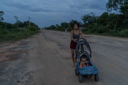 Una joven pasea a su hijo por el arcén de la carretera amazónica BR319, en Manicoré, en octubre pasado. 