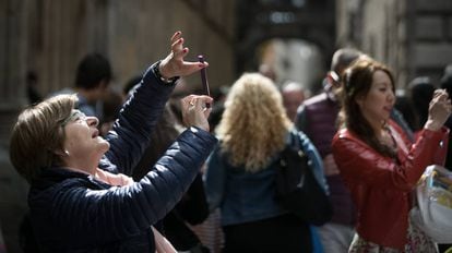 Turistas hacen fotografías con sus teléfonos móviles, en Barcelona.